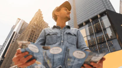 Young man exploring the cityscape, holding a map in hand
